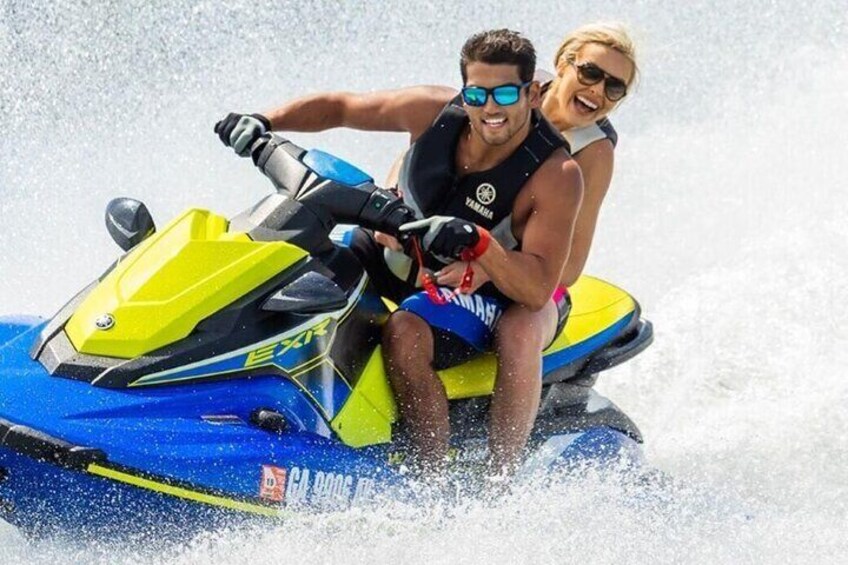 Two people on a jet ski. 1