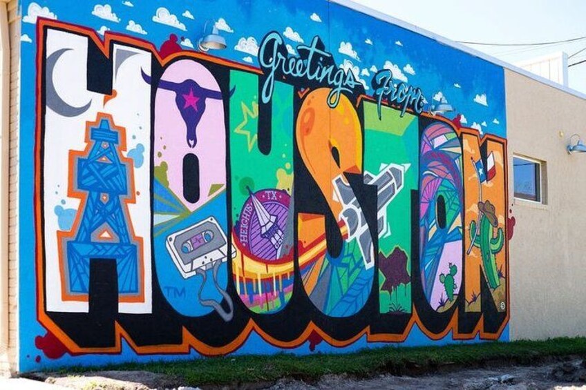 A colorful mural with the word 'TEXAS' and various icons like a space shuttle, a cow, and a cactus. 3