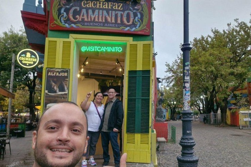A colorful building with a sign reading 'Cachafaz Camino' and 'Alfajor' visible. 3