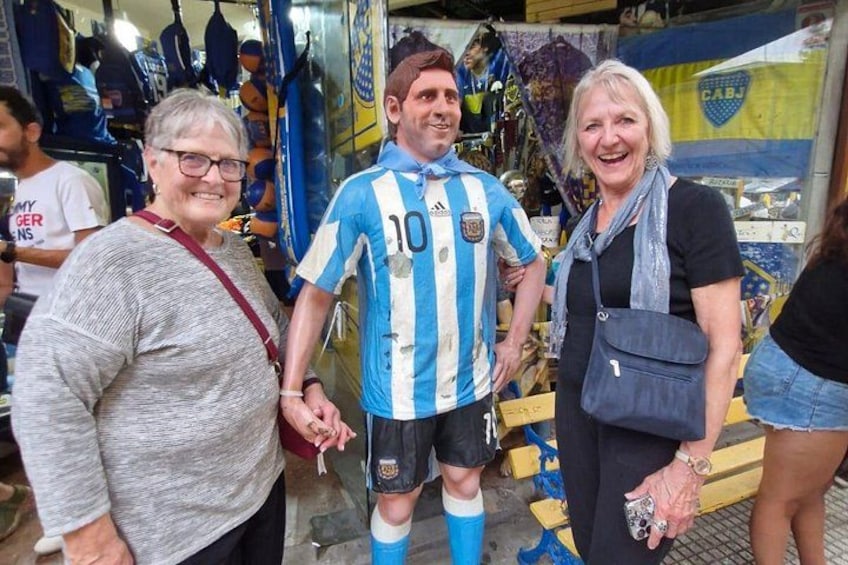 A person in a blue and white striped sports jersey, a woman in a gray sweater, and another woman in a black top and blue scarf. 5