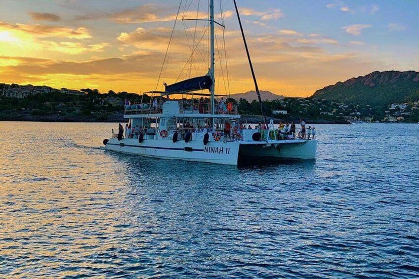 A boat named 'NINAH II' on calm waters with a sunset in the background. 3