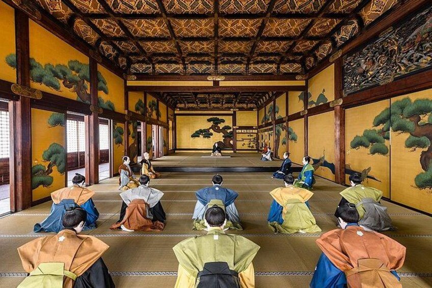 A traditional Japanese room with tatami mats, wooden beams, and paintings of trees. 2
