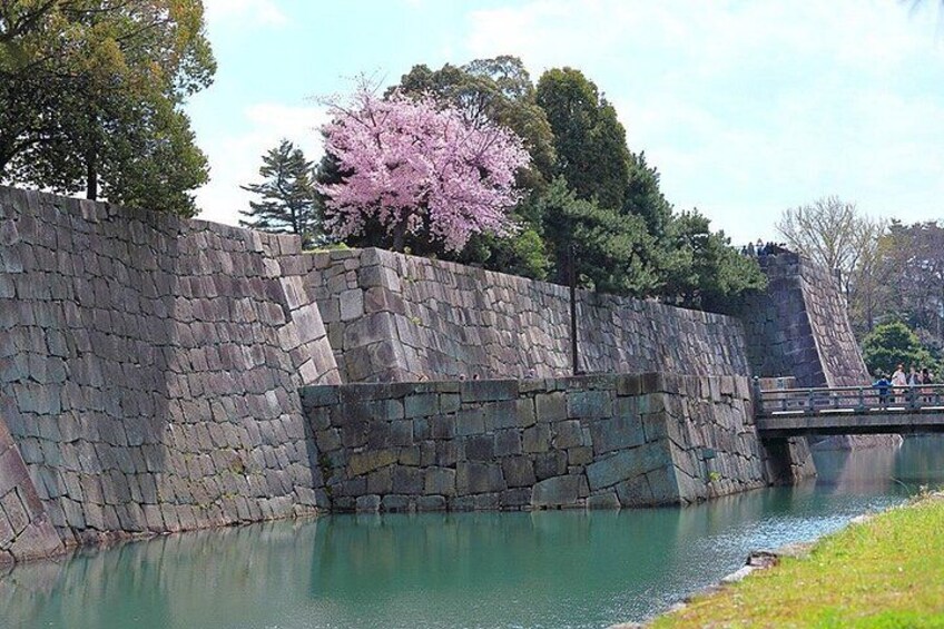A stone wall, a bridge, and a body of water. 3