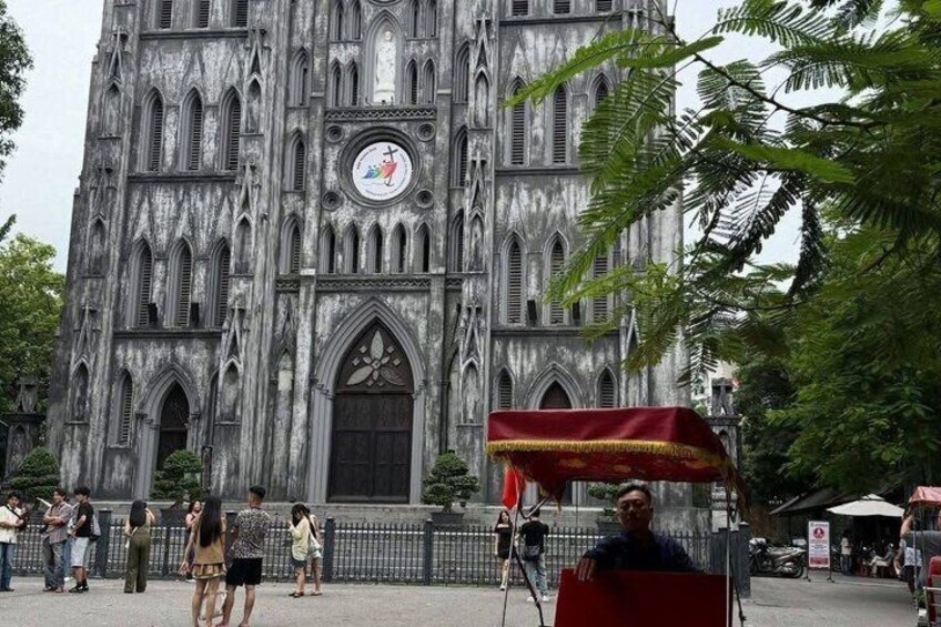 A Gothic-style church with a clock and a red canopy. 5
