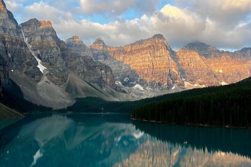 A mountain range with a lake reflecting the peaks. 3