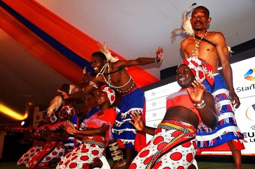 A group of people in traditional attire performing a dance. 3