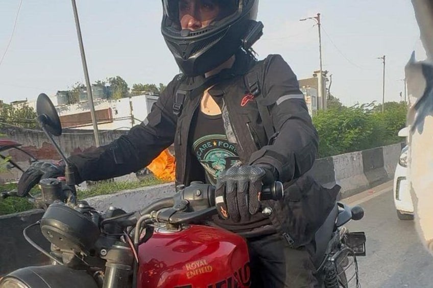 A person on a motorcycle with a helmet, gloves, and a jacket. 1