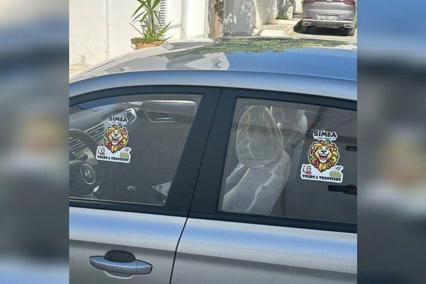 A car with stickers on the windows and a logo on the side. 4