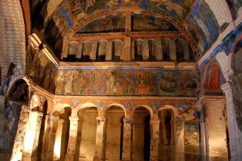 An interior of a historical building with detailed frescoes and arches. 4