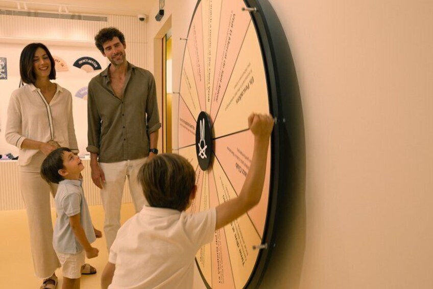 A family interacting with a large wall clock. 2