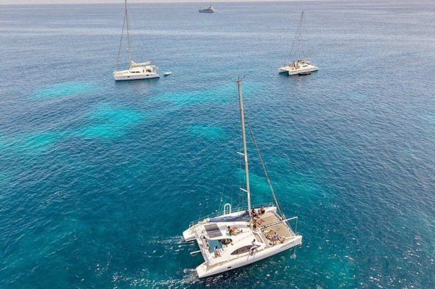 A sailboat with a mast and rigging, surrounded by calm blue waters. 2