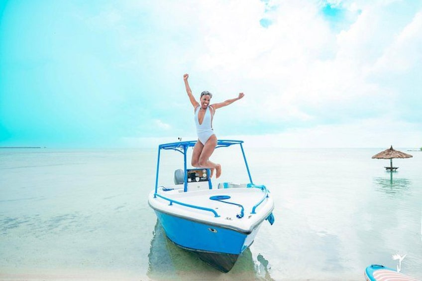 A person on a small boat in calm waters. 2