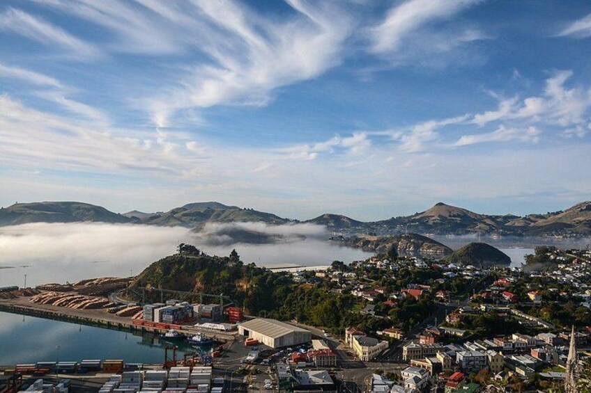 A coastal town with a harbor, buildings, and hills in the background. 5