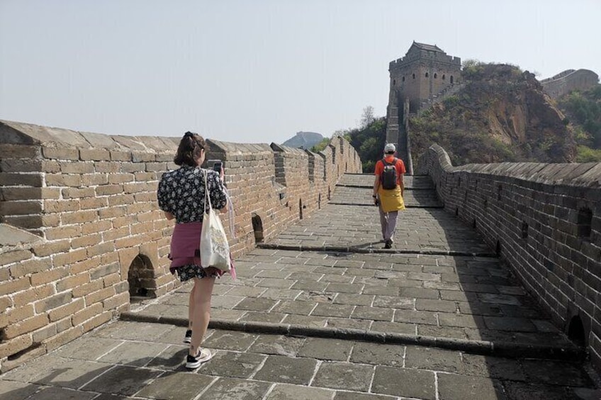 A person taking a photo on the Great Wall of China. 5
