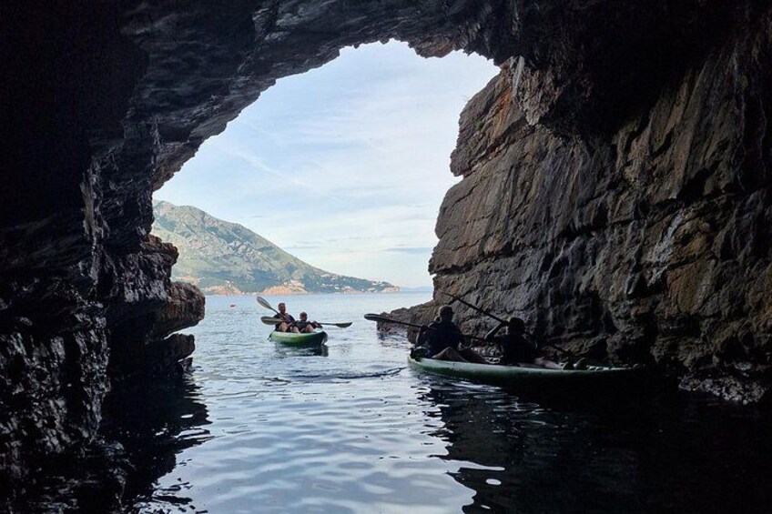 Kayakers in a narrow waterway between rocky cliffs. 3