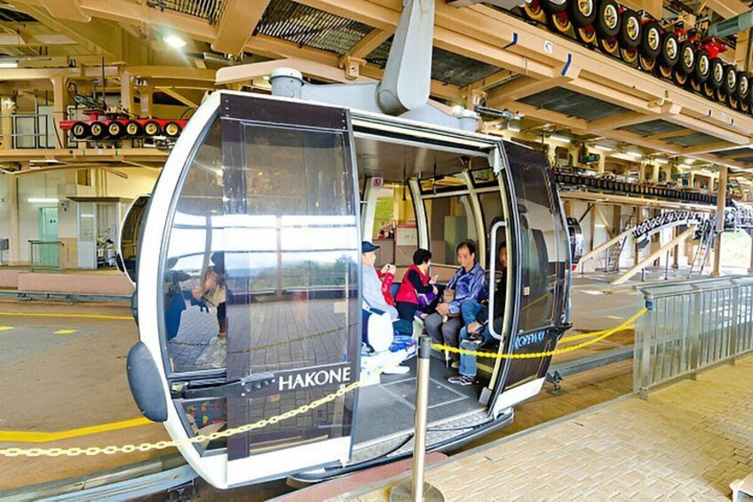 A cable car with passengers, a tire display, and a metal staircase. 4