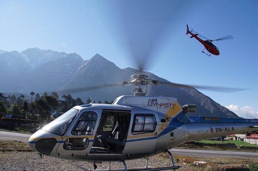 A helicopter on a helipad with mountains in the background. 5