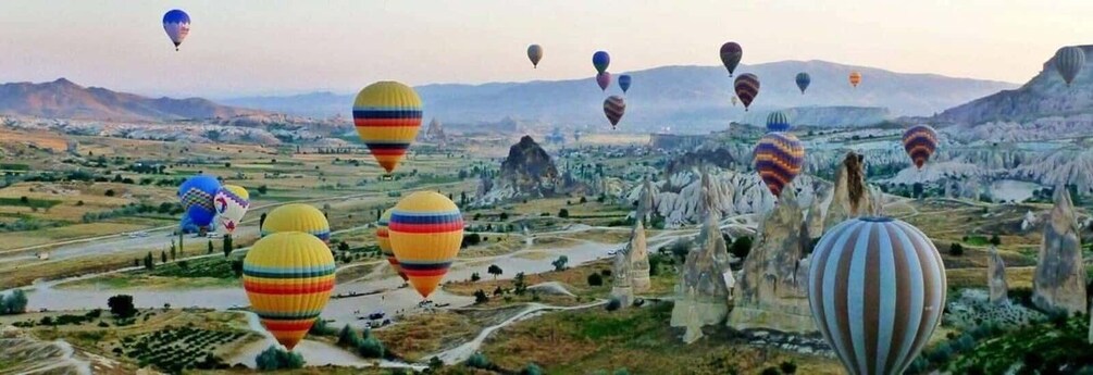 A landscape with hot air balloons and unique rock formations. 5