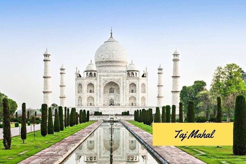 The Taj Mahal with its reflection in the water, four minarets, and the surrounding garden. 2
