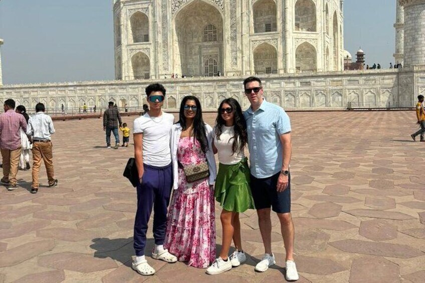 A group of people standing in front of the Taj Mahal. 4