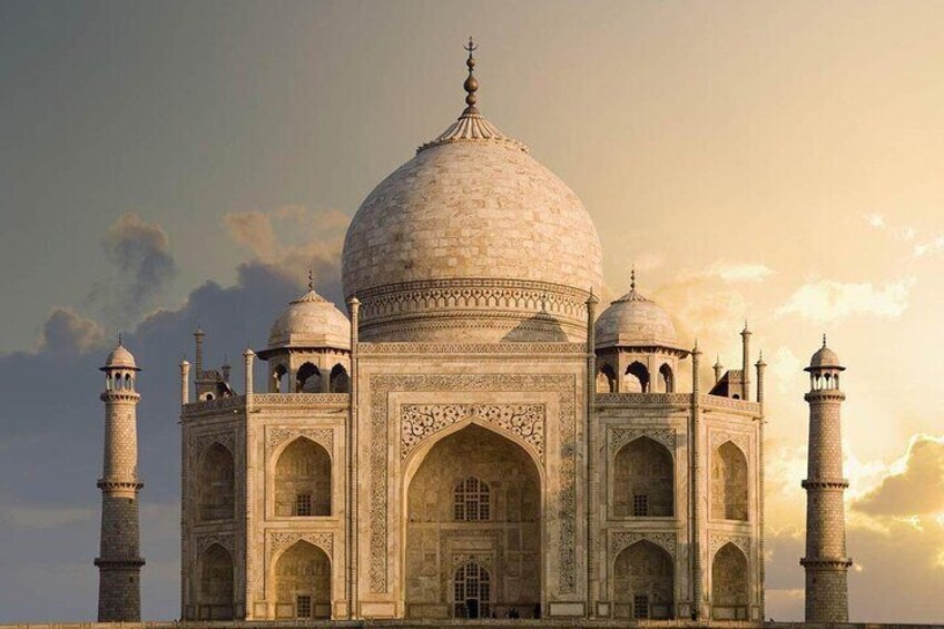 The Taj Mahal with four minarets, a large central dome, and four smaller domes. 3