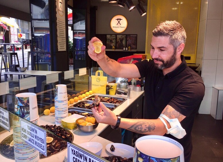 A person preparing food at a counter with various dishes and utensils. 5