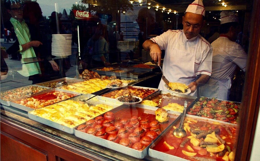 A buffet with various dishes, including pasta, salads, and seafood. 4