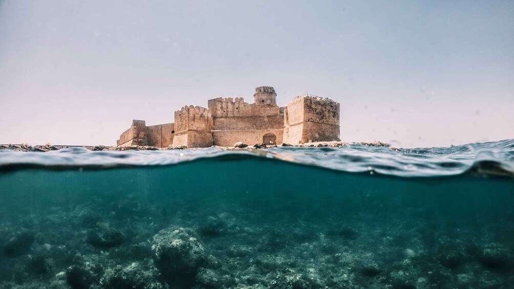 A coastal castle with a clear view of the surrounding ocean. 3
