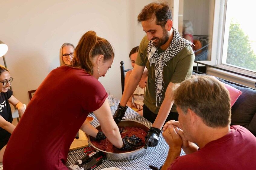 A group of people preparing food in a kitchen. 1