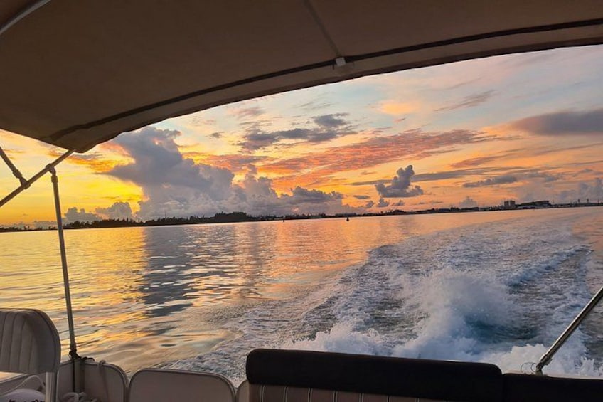 Een boot op het water, met een zonsondergang op de achtergrond. 2