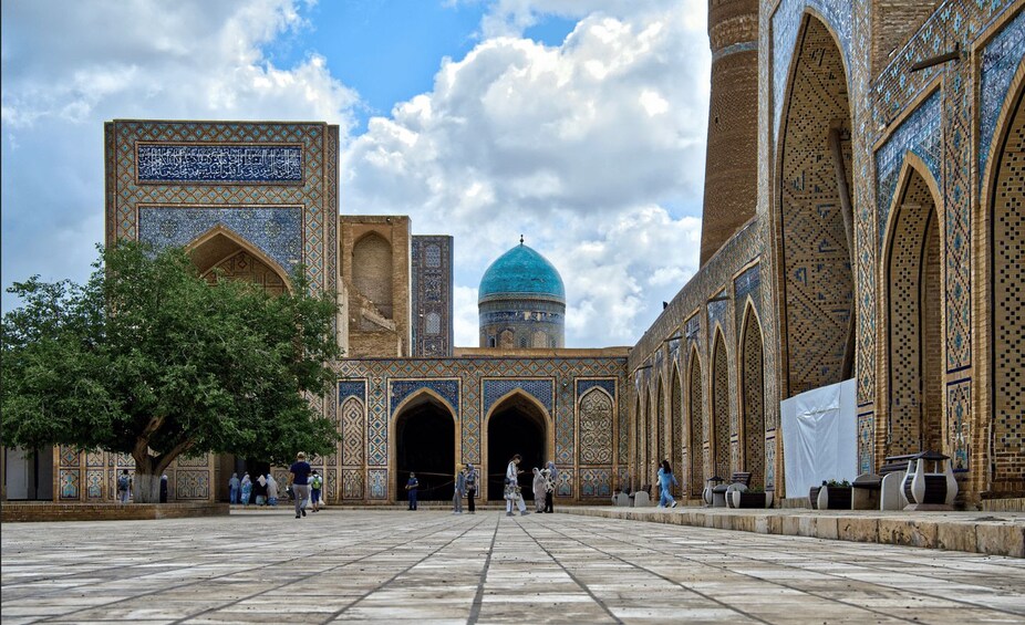 A historic building with intricate tile work and a prominent dome. 2