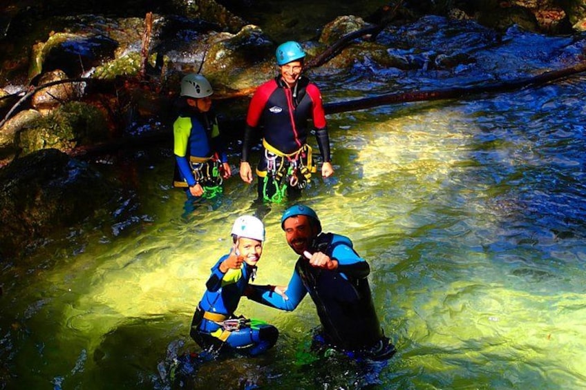 People in water with helmets and life jackets, engaged in a water activity. 5