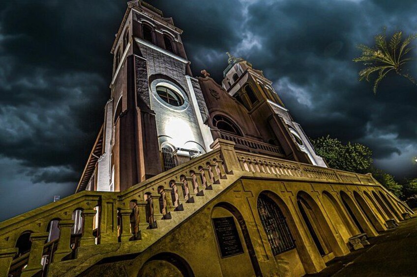 A church with a bell tower and a staircase leading up to it. 4