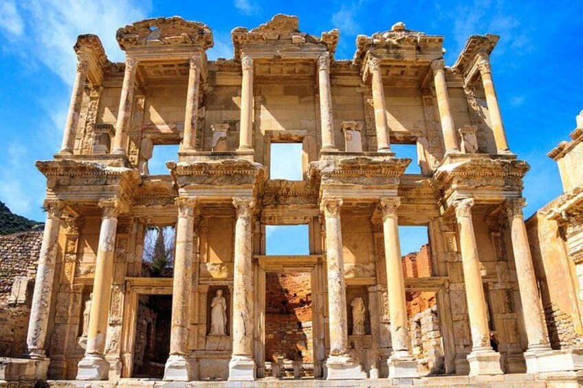 An ancient ruin with columns and statues. 4