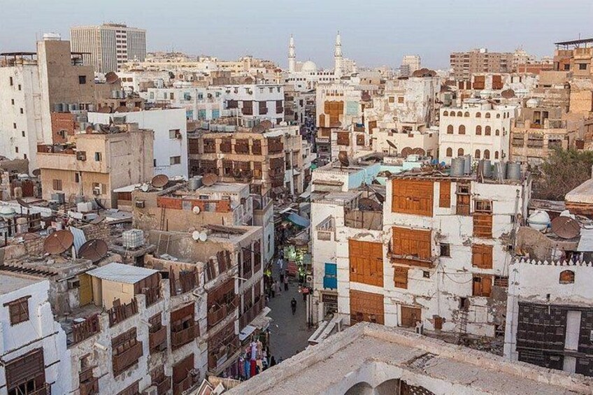 A densely packed urban area with closely built structures, narrow streets, and a prominent minaret. 4