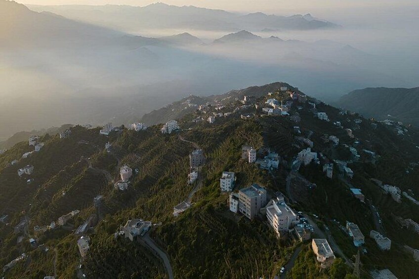 A mountainous landscape with scattered buildings and winding roads. 4