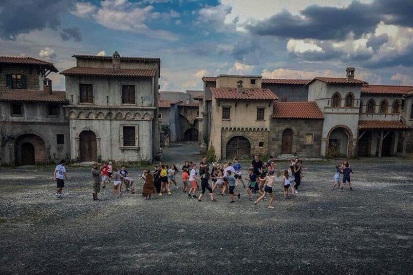 A group of people dancing in a courtyard surrounded by historic buildings. 2