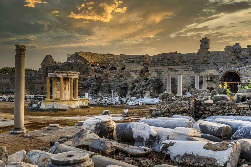 Ancient ruins with columns and stone structures under a cloudy sky. 2