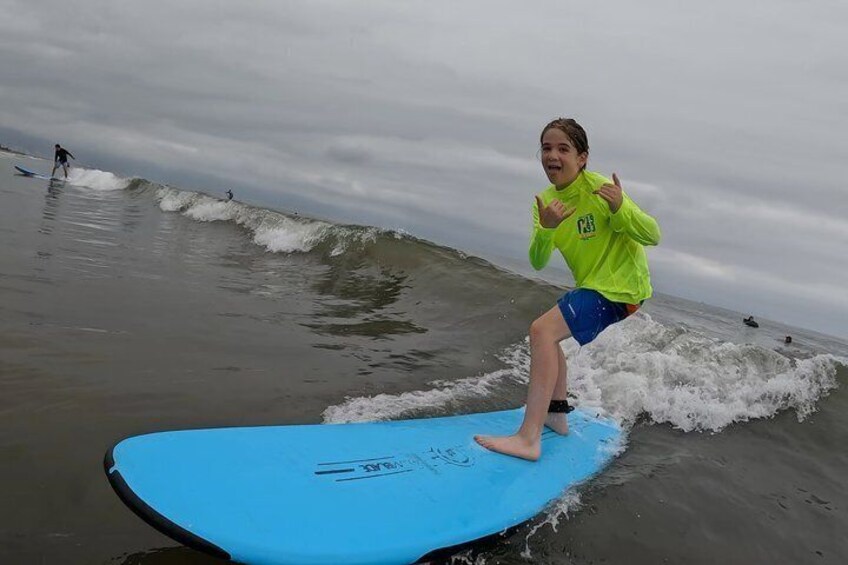 A person surfing on a blue board in the ocean. 1