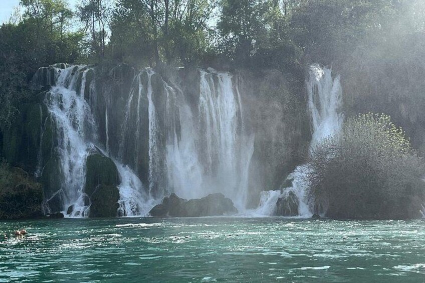A waterfall cascading over a rocky cliff into a body of water. 5