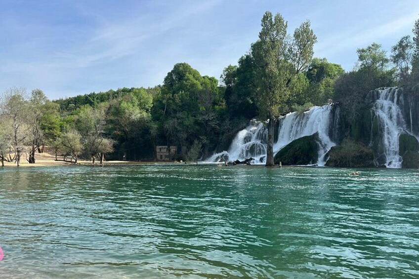A waterfall, trees, and a body of water. 4