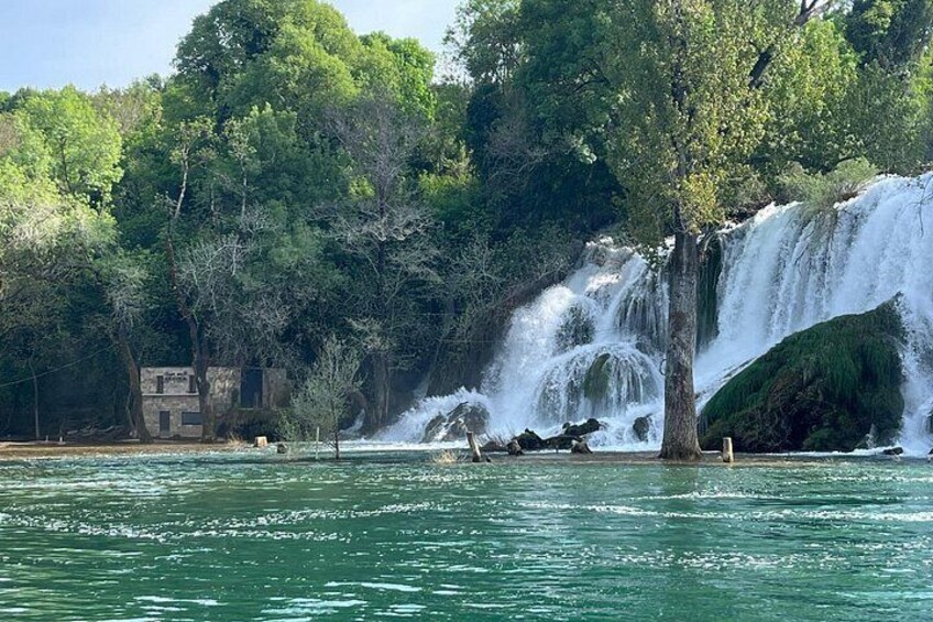 A waterfall with cascading water surrounded by lush greenery and trees. 3