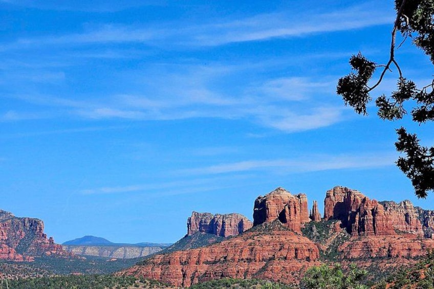 A desert landscape with prominent red rock formations under a clear blue sky. 4