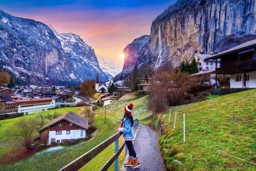 A person walking on a path with a mountainous landscape in the background. 5