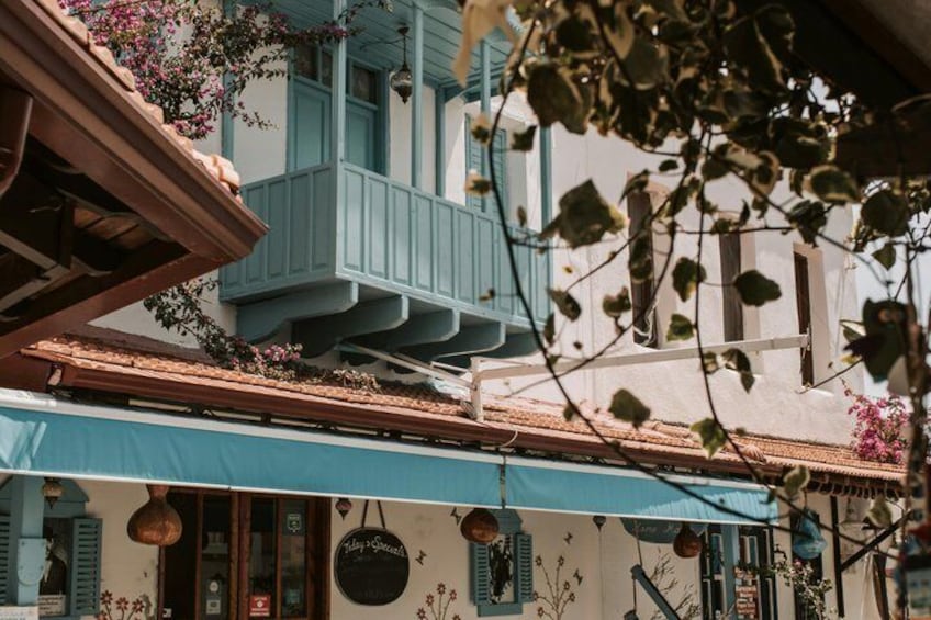 A building with a blue balcony and hanging lanterns. 2
