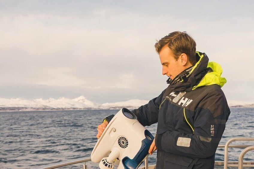 A person on a boat holding a navigation device. 2