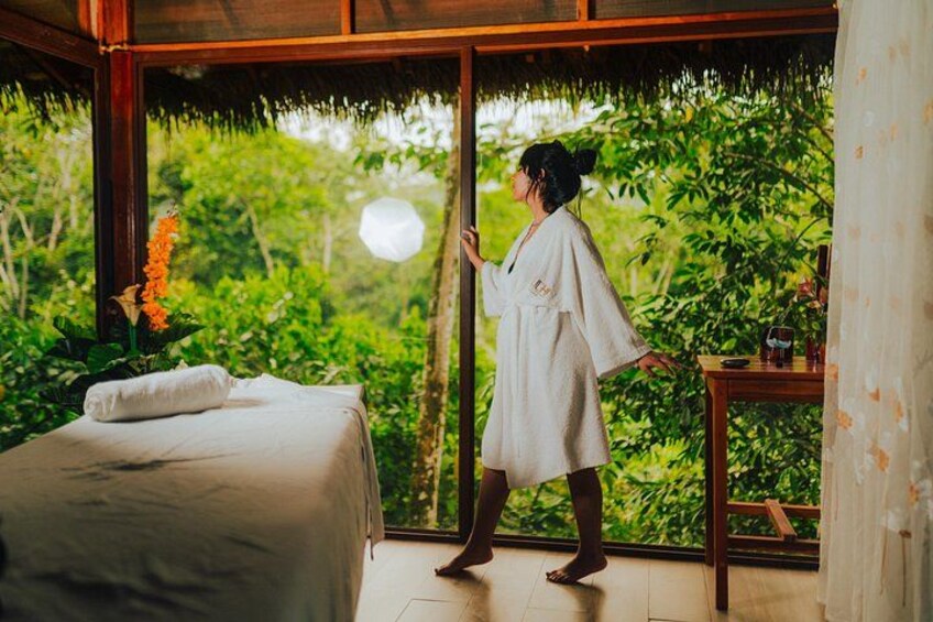 A room with a bed, a window, and a person standing by the window. 5
