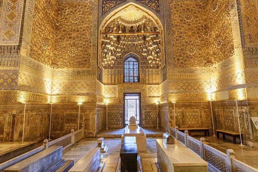 An ornate interior with intricate tile work and a central arched window. 3