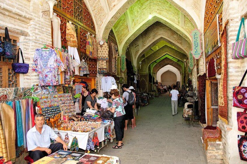 A bustling market with stalls selling textiles and crafts. 4