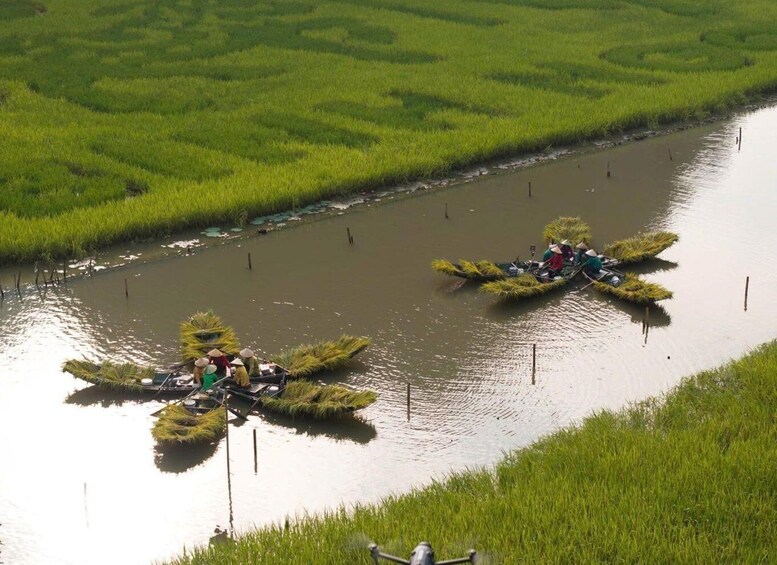 Two canoes on a river surrounded by lush green fields. 4